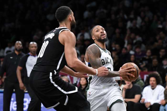  Milwaukee Bucks guard Damian Lillard (0) drives to the basket against Brooklyn Nets guard Ben Simmons (10) 